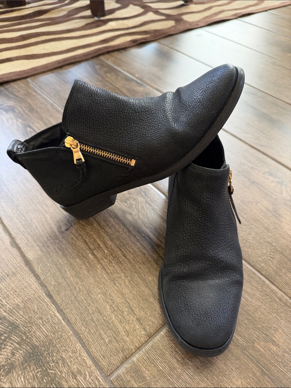 UGG Black Leather Ankle Booties with Gold Zipper Accent